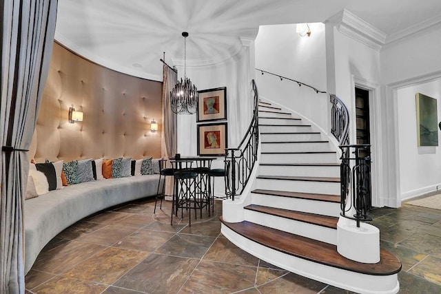 stairs with dark tile flooring, ornamental molding, and a chandelier