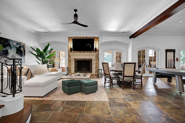 living room featuring dark tile floors, ceiling fan, brick wall, a fireplace, and beam ceiling