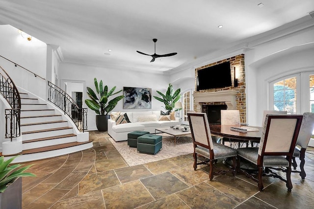 tiled dining space featuring ceiling fan, a brick fireplace, brick wall, and crown molding