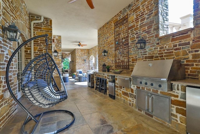 view of patio with exterior kitchen, area for grilling, and ceiling fan