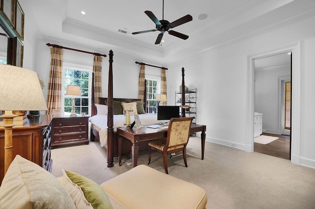 dining area featuring ceiling fan, crown molding, light carpet, and a tray ceiling