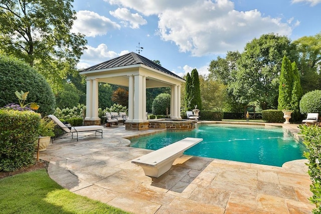 view of swimming pool featuring a patio, a gazebo, and a diving board