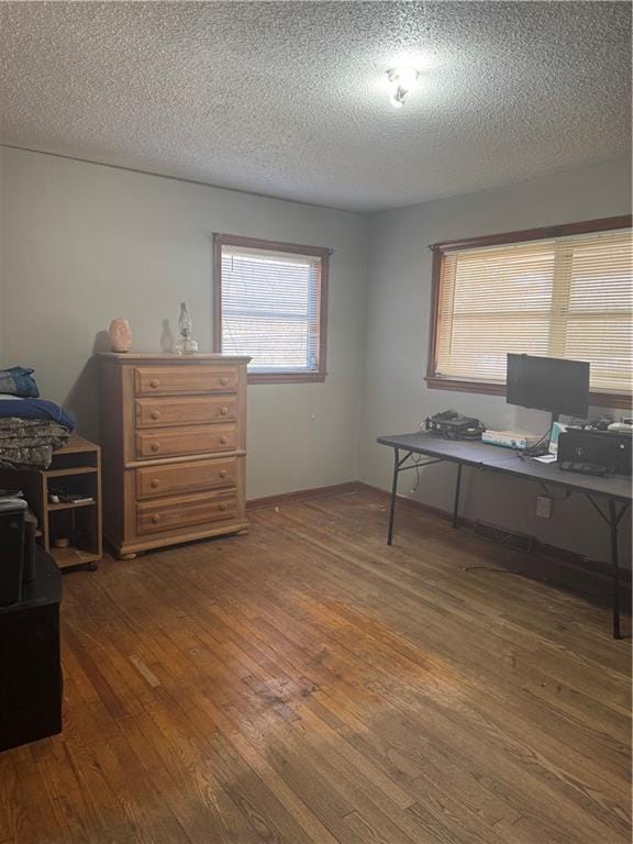 office with dark hardwood / wood-style flooring and a textured ceiling