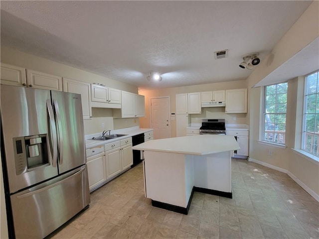 180 Preston Oaks Dr, Johns Creek, GA 30022 - kitchen featuring appliances with stainless steel finishes, under cabinet range hood, light countertops, white cabinets, and a textured ceiling