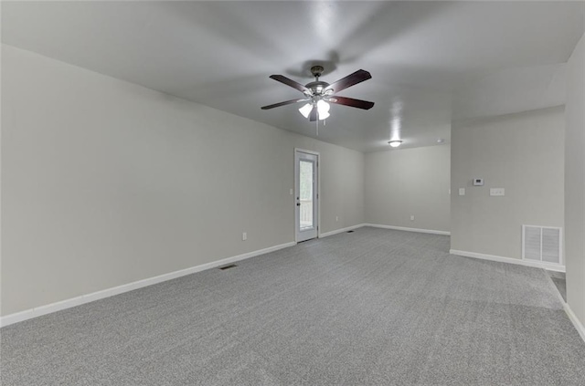 spare room with ceiling fan, baseboards, and carpet flooring