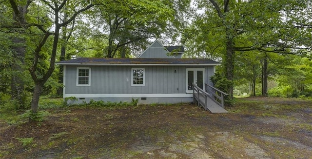 rear view of property featuring crawl space, french doors, and entry steps