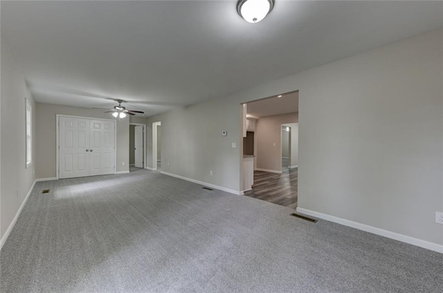 unfurnished room with carpet floors, ceiling fan, and baseboards