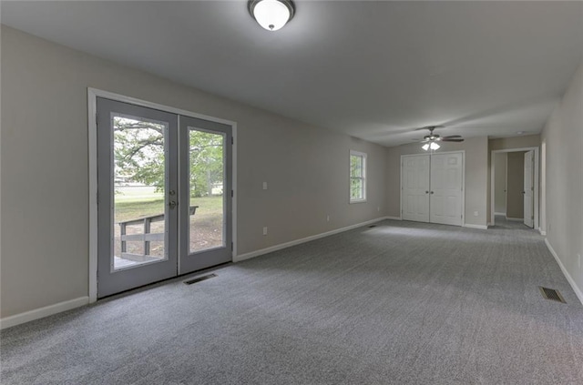 unfurnished room with baseboards, carpet flooring, french doors, and a ceiling fan