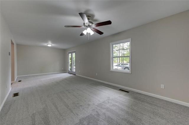 unfurnished room featuring baseboards, carpet floors, and ceiling fan