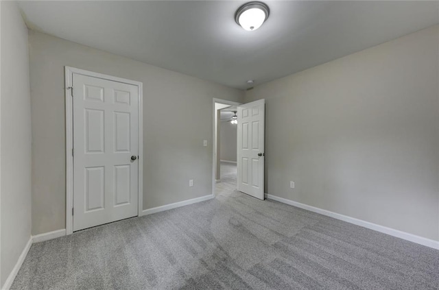 unfurnished bedroom featuring carpet floors and baseboards