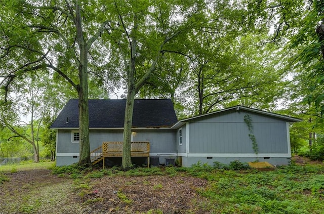 rear view of house with crawl space, a deck, and central air condition unit