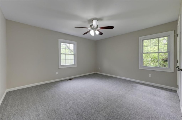 spare room with baseboards, carpet, and ceiling fan