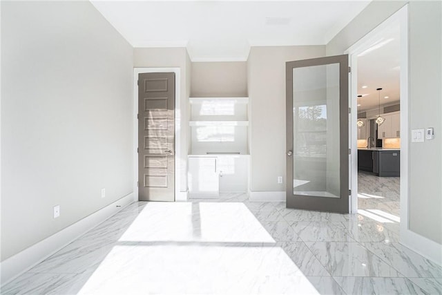 bedroom with marble finish floor, ensuite bath, and baseboards