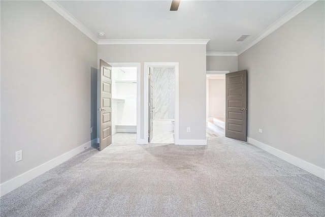 unfurnished bedroom with ensuite bath, baseboards, crown molding, and carpet flooring
