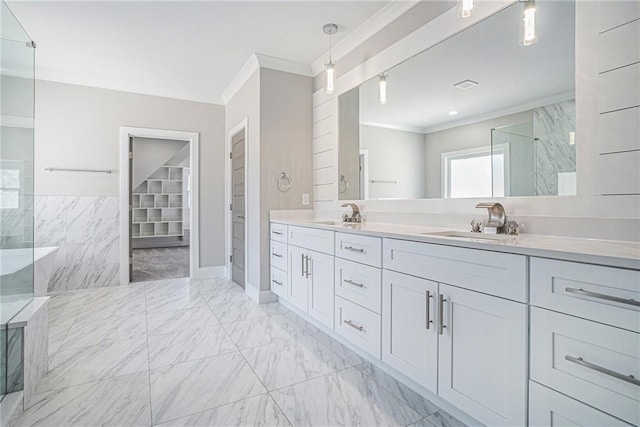 bathroom featuring marble finish floor, double vanity, ornamental molding, a sink, and a walk in shower