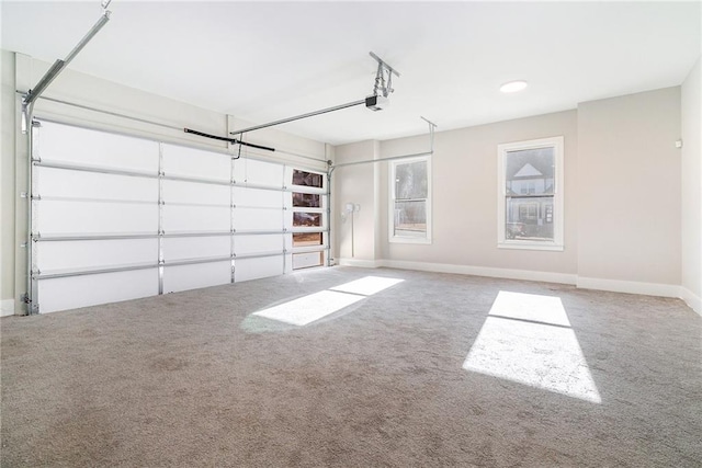 garage featuring a garage door opener and baseboards