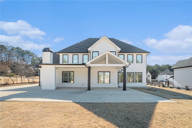 modern inspired farmhouse featuring a patio area and fence