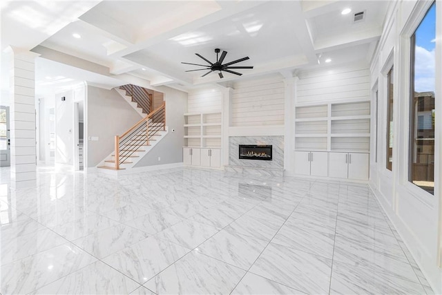 unfurnished living room with visible vents, coffered ceiling, stairway, beamed ceiling, and built in shelves