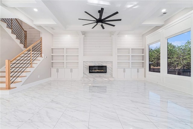 unfurnished living room featuring marble finish floor, stairway, a ceiling fan, and built in features