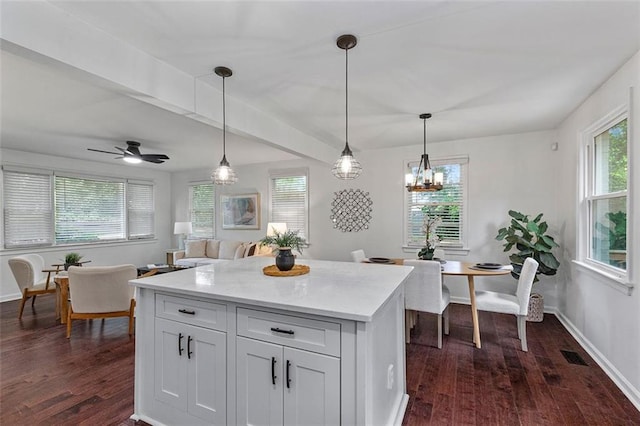 kitchen featuring dark wood-style floors, decorative light fixtures, white cabinetry, and baseboards