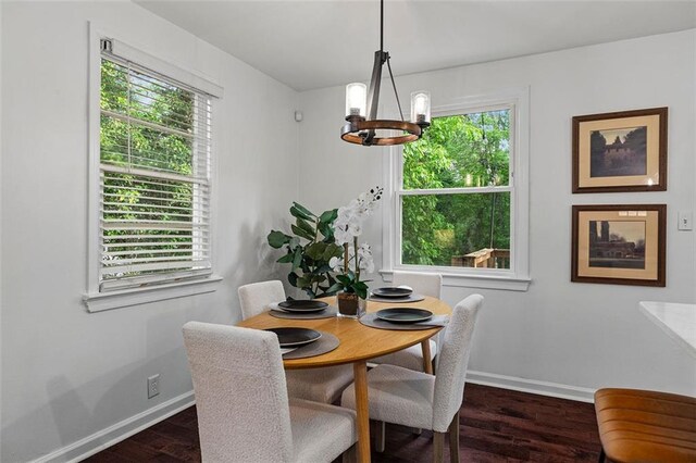 dining room with baseboards, an inviting chandelier, and dark wood-style floors