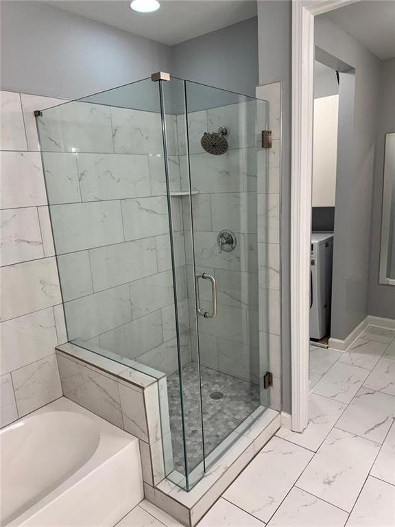711 Cosmopolitan Dr NE Unit 426, Atlanta, GA 30324 - bathroom featuring a bath, marble look tile flooring, a stall shower, baseboards, and recessed lighting