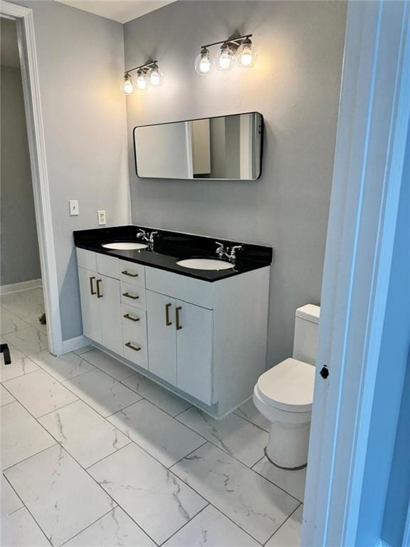 711 Cosmopolitan Dr NE Unit 426, Atlanta, GA 30324 - bathroom with marble finish floors, double vanity, toilet, and baseboards