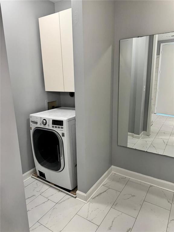 711 Cosmopolitan Dr NE Unit 426, Atlanta, GA 30324 - laundry room with washer / dryer, light marble finish flooring, baseboards, and cabinet space