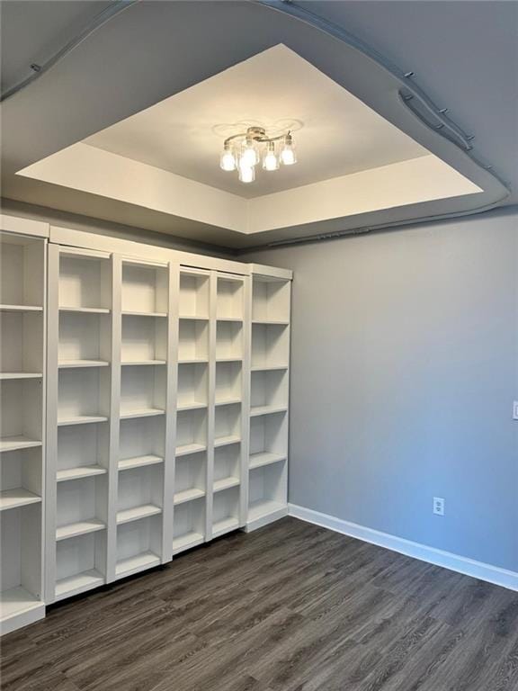 711 Cosmopolitan Dr NE Unit 426, Atlanta, GA 30324 - spare room featuring a tray ceiling, dark wood-style floors, and baseboards