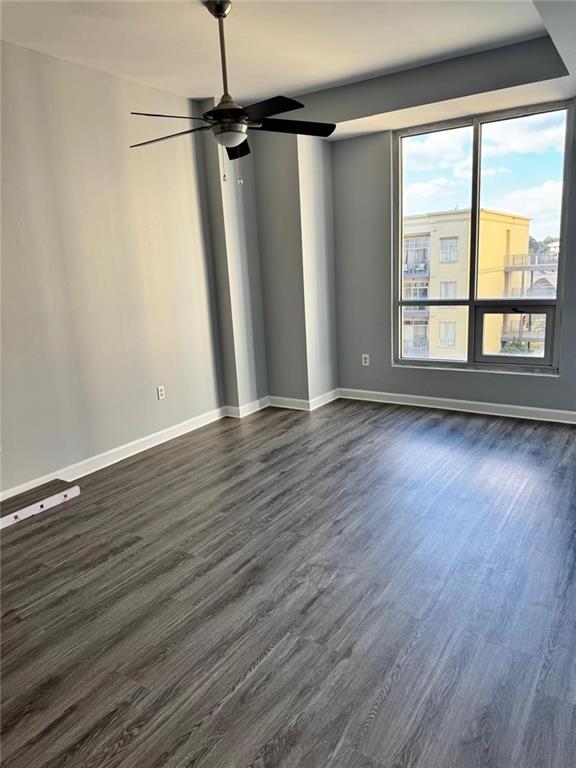 711 Cosmopolitan Dr NE Unit 426, Atlanta, GA 30324 - empty room featuring dark wood-style flooring, baseboards, and a ceiling fan