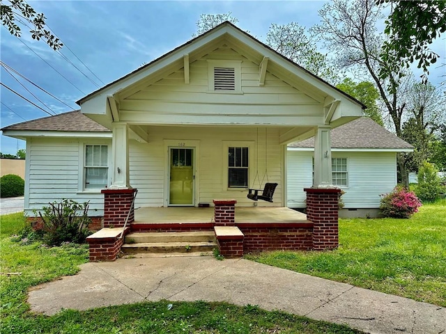 bungalow-style house featuring a front lawn and a porch