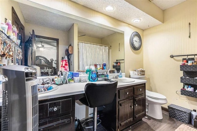 6230 S Summers Cir S, Douglasville, GA 30135 - full bathroom featuring toilet, vanity, wood finished floors, a ceiling fan, and curtained shower