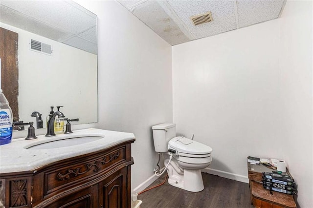 6230 S Summers Cir S, Douglasville, GA 30135 - bathroom with vanity, toilet, wood finished floors, baseboards, and a drop ceiling