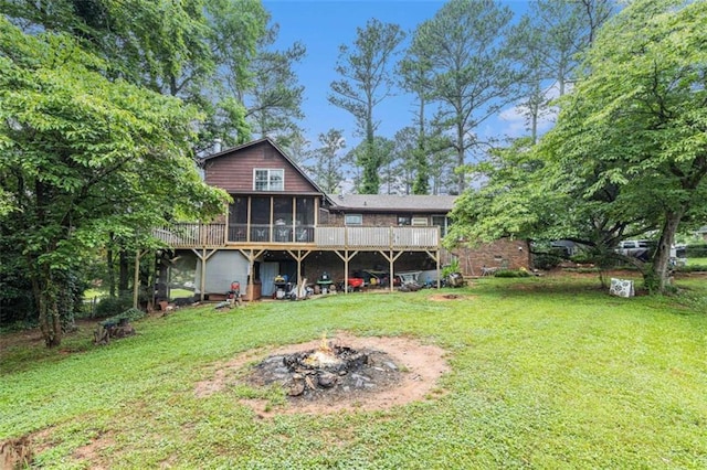 6230 S Summers Cir S, Douglasville, GA 30135 - rear view of property featuring a sunroom, an outdoor fire pit, a yard, and a wooden deck