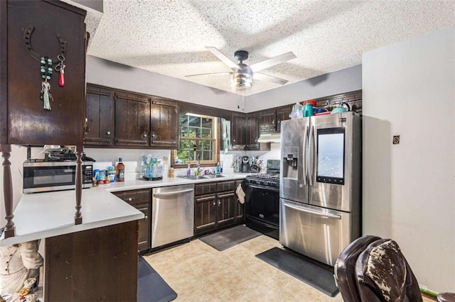 6230 S Summers Cir S, Douglasville, GA 30135 - kitchen featuring stainless steel appliances, a sink, a textured ceiling, dark brown cabinetry, and under cabinet range hood