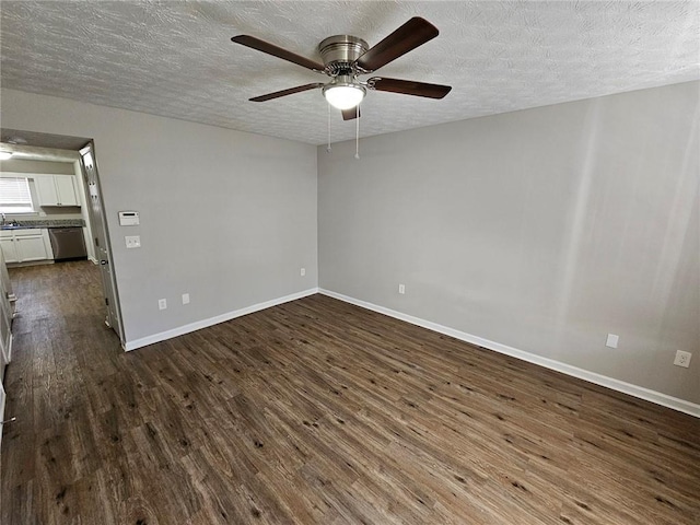 6500 Wellington Chase Ct, Lithonia, GA 30058 - empty room with baseboards, dark wood finished floors, a textured ceiling, a ceiling fan, and a sink