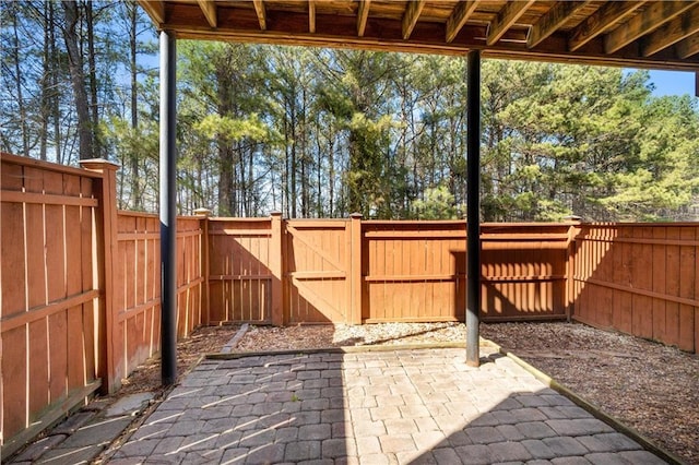 view of patio featuring a fenced backyard and a gate
