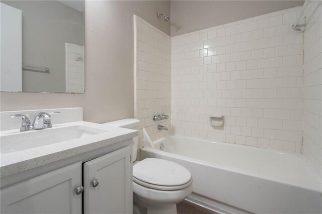 bathroom with vanity, bathtub / shower combination, and toilet