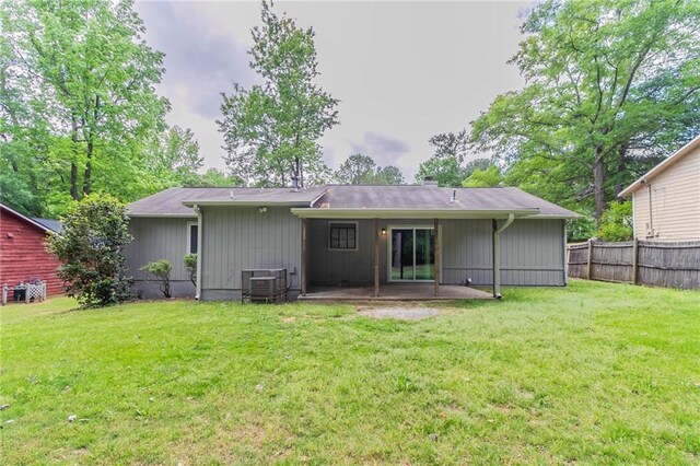 back of house with a yard, fence, central AC unit, and a patio area