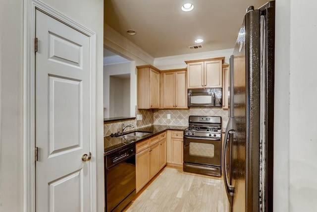 kitchen with light brown cabinets, a sink, visible vents, black appliances, and crown molding