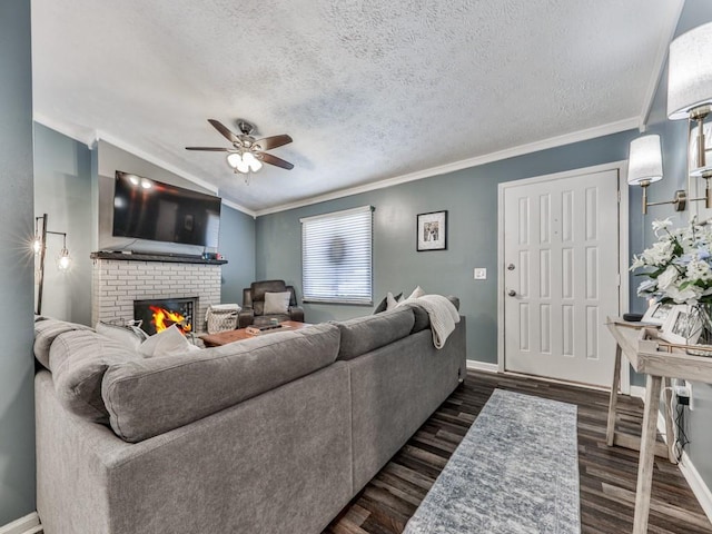 living area with a brick fireplace, crown molding, baseboards, a textured ceiling, and dark wood-style flooring