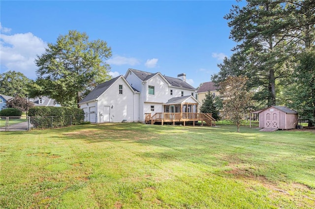 rear view of property with a yard, a deck, and a shed