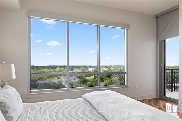bedroom with multiple windows and a water view