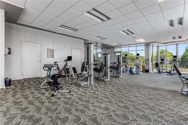 gym with carpet floors, baseboards, a drop ceiling, french doors, and arched walkways