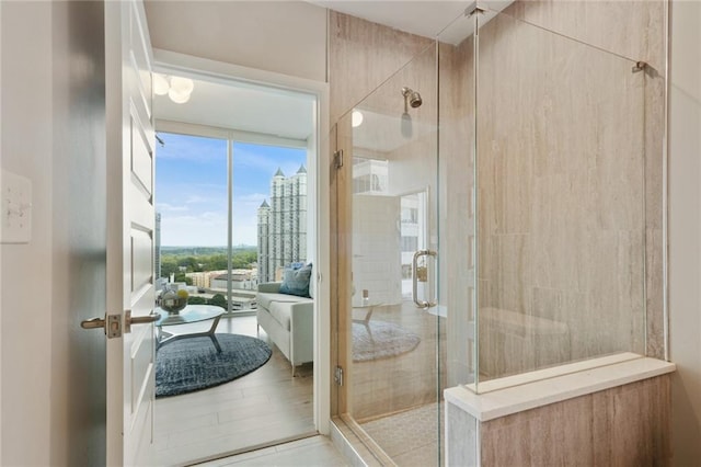 bathroom featuring a shower with door