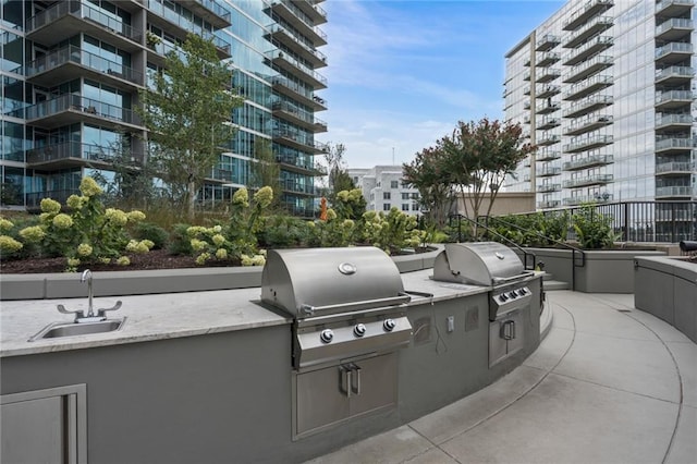 view of patio featuring a grill, sink, and exterior kitchen