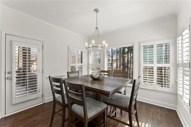 dining area with dark wood-style floors, baseboards, a chandelier, and crown molding