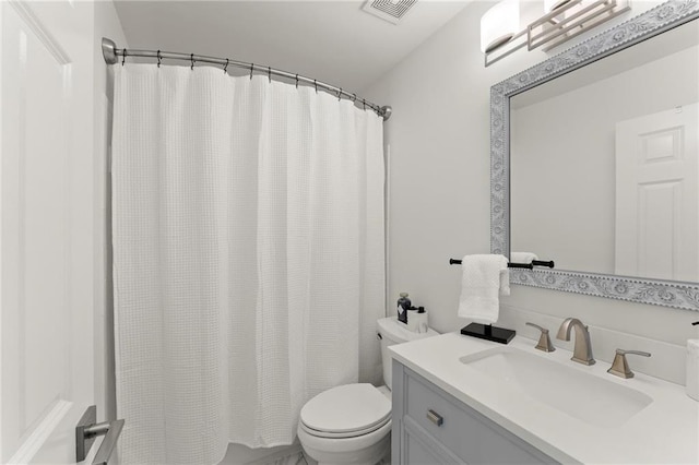 full bathroom featuring toilet, shower / tub combo, visible vents, and vanity