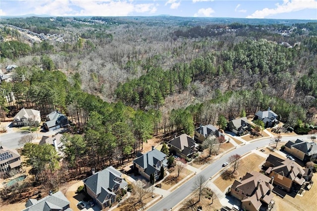 birds eye view of property featuring a wooded view and a residential view