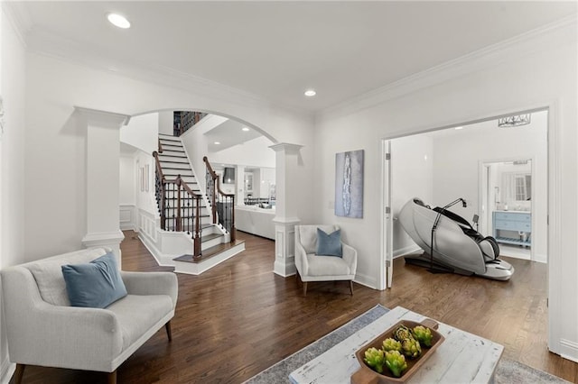 interior space with decorative columns, ornamental molding, wood finished floors, and recessed lighting